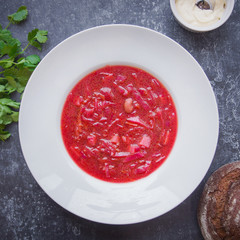 Borsch in a white plate, Menu, Russian cuisine recipe, Top view, Dark background