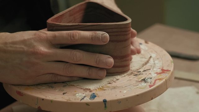 Ceramist work in the workshop.
