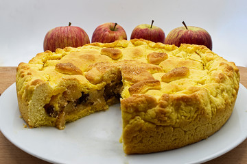 Freshly baked homemade apple pie with apples fruit on background