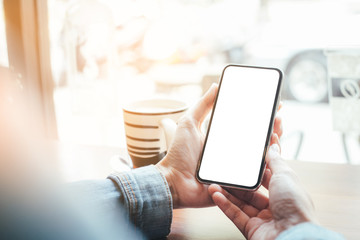 cell phone Mockup image blank white screen.woman hand holding texting using mobile on desk at coffee shop.background empty space for advertise text.people contact marketing business,technology