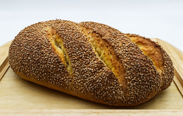 Traditional loaf of Sicilian bread with sesame on wooden table
