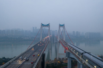 Aerial drone shot of Egongyan bridge over Yangtze River in early morning with fog