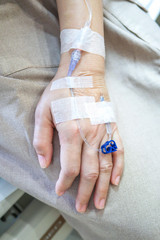 Patient's hand with drip receiving a saline solution.