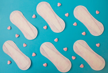 Menstruation cycle concept. Menstrual calendar with sanitary pads on a blue background