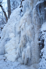Fototapeta na wymiar Icy waterfall on a mountain river.