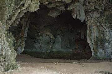 cave on black beach in palawan, philippines