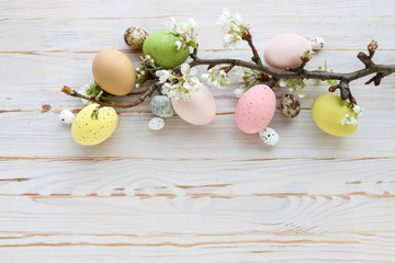 Colorful Easter eggs and blooming apple tree branch