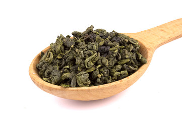 Dry tea in a wooden spoon, isolated on white background, delicious, natural