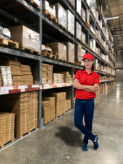 Woman operator in uniform with Blurred the background of the warehouse storage