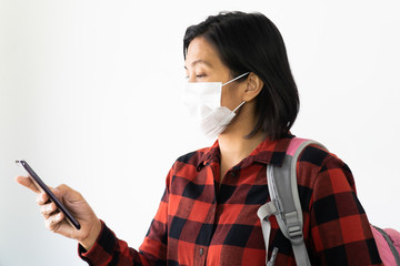 Traveller woman under surgical face mask covering mouth and nose. Awareness and Watch out Corona Virus or COVID-19 concept.