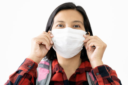 Traveller woman under surgical face mask covering mouth and nose. Awareness and Watch out Corona Virus or COVID-19 concept.
