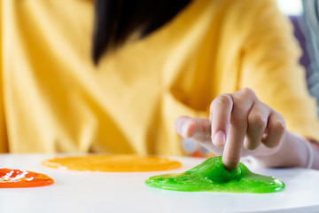 Hand Holding Homemade Toy Called Slime, Kids having fun and being creative by science experiment