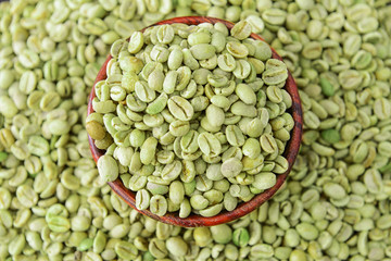 Bowl with green coffee beans, closeup