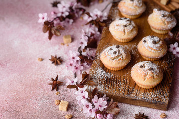 Fresh baked cupcakes of rice flour with banana and vanilla with a mug of hot chocolate