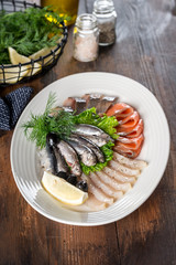 Slicing of different fish in one white plate