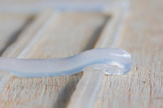 Silicone glue stuck on a sheet of wood