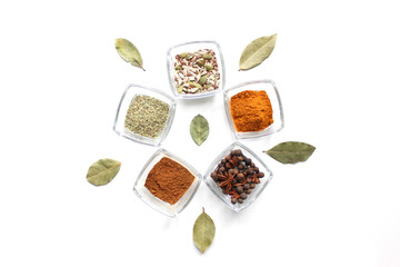 Top view mix indian spices and herbs glass pots on white background with copy space for design vegetable, healthy lifestyle, spices, herbs or foods content