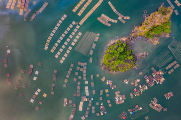 Aerial view fishing village and rock island, Bai Tu Long Bay, Vietnam, Southeast Asia. UNESCO World Heritage Site. Junk boat cruise to Ha Long Bay. Popular landmark, famous destination of Vietnam