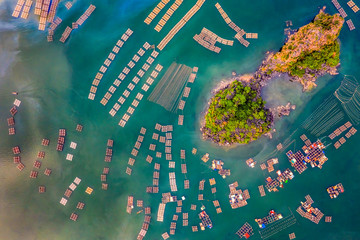 Aerial view fishing village and rock island, Bai Tu Long Bay, Vietnam, Southeast Asia. UNESCO World Heritage Site. Junk boat cruise to Ha Long Bay. Popular landmark, famous destination of Vietnam