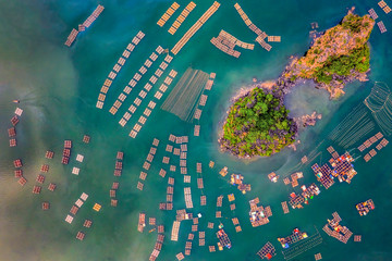 Aerial view fishing village and rock island, Bai Tu Long Bay, Vietnam, Southeast Asia. UNESCO World Heritage Site. Junk boat cruise to Ha Long Bay. Popular landmark, famous destination of Vietnam