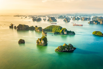 Aerial view floating fishing village and rock island, Halong Bay, Vietnam, Southeast Asia. UNESCO World Heritage Site. Junk boat cruise to Ha Long Bay. Popular landmark, famous destination of Vietnam © Hien Phung