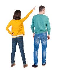 Back view of couple in sweater pointing.