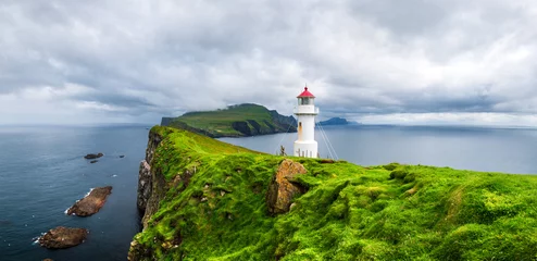 Foto op Canvas Panoramic view of old lighthouse on the Mykines island, Faroe islands, Denmark. Landscape photography © Ivan Kmit