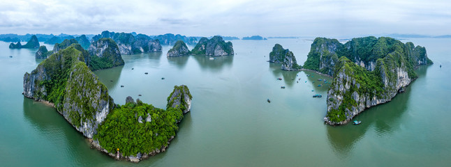 Aerial view Ba Hang floating fishing village, rock island, Halong Bay, Vietnam, Southeast Asia. UNESCO World Heritage Site. Junk boat cruise to Ha Long Bay. Famous destination of Vietnam © Hien Phung