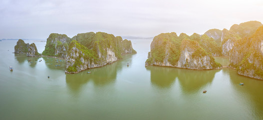 Aerial view Ba Hang floating fishing village, rock island, Halong Bay, Vietnam, Southeast Asia. UNESCO World Heritage Site. Junk boat cruise to Ha Long Bay. Famous destination of Vietnam © Hien Phung