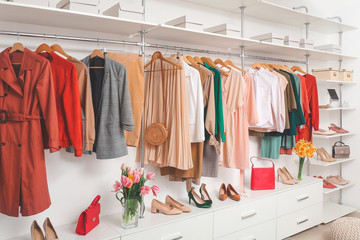 Modern wardrobe with stylish spring clothes and accessories