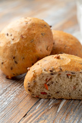 Onion bread sliced in halves, with its fluffy texture visible, close up shot on wooden table