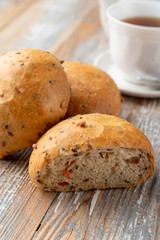 Onion bread sliced in halves, with its fluffy texture visible, close up shot on wooden table