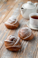 Traditional russian buns with sweet filling, close up shot on old wooden table