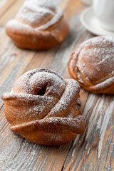 Traditional russian buns with sweet filling, close up shot on old wooden table