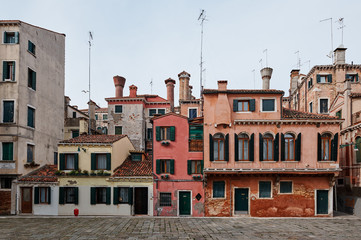 Venice, Italy - February 19, 2020: Colorful houses in the old medieval street in Venice, Veneto, Italy
