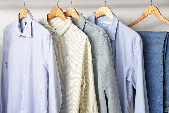 Stylish Male Clothes On Hanger In Wardrobe