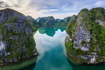 Aerial view of Cua Van floating fishing village and rock island, Halong Bay, Vietnam, Southeast Asia. UNESCO World Heritage Site. Junk boat cruise to Ha Long Bay. Famous destination of Vietnam © Hien Phung