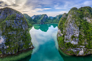 Aerial view of Cua Van floating fishing village and rock island, Halong Bay, Vietnam, Southeast Asia. UNESCO World Heritage Site. Junk boat cruise to Ha Long Bay. Famous destination of Vietnam © Hien Phung