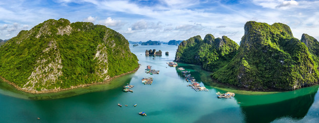 Aerial view of Cua Van floating fishing village and rock island, Halong Bay, Vietnam, Southeast Asia. UNESCO World Heritage Site. Junk boat cruise to Ha Long Bay. Famous destination of Vietnam © Hien Phung