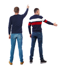 Obraz premium Back view of two man in sweater pointing.