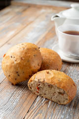 Onion bread sliced in halves, with its fluffy texture visible, close up shot on wooden table