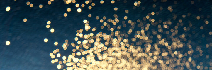 Panoramic background from golden blurred lens flares on blue waves.
