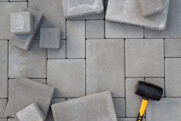 Paving stones paving background. Installing tools on foreground