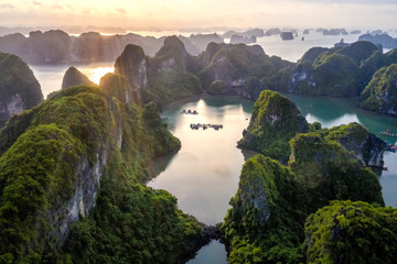 Aerial view Vung Vieng floating fishing village and rock island, Halong Bay, Vietnam, Southeast Asia. UNESCO World Heritage Site. Junk boat cruise to Ha Long Bay. Famous destination of Vietnam © Hien Phung