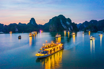 Aerial view floating fishing village and rock island, Halong Bay, Vietnam, Southeast Asia. UNESCO World Heritage Site. Junk boat cruise to Ha Long Bay. Popular landmark, famous destination of Vietnam © Hien Phung