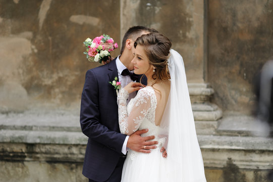 Wedding photo session of a young beautiful couple in the old city.