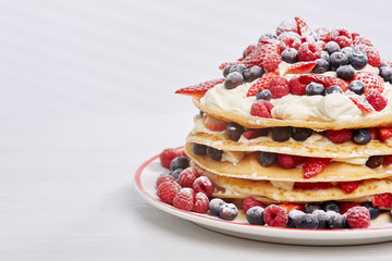 Pancakes with berries and sugar.