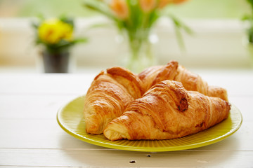 Breakfast with fresh croissants on white  wooden board