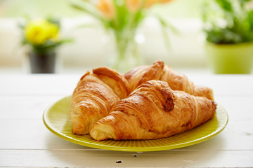 Breakfast with fresh croissants on white  wooden board