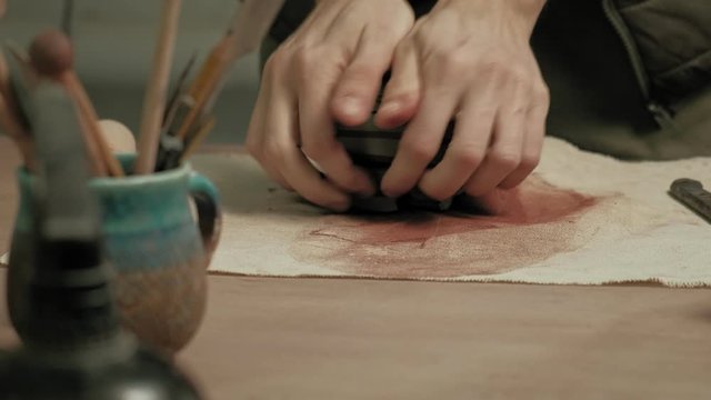 Ceramist work in the workshop.